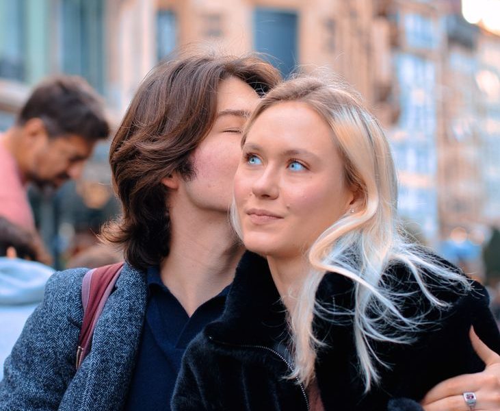 boyfriend kissing his girlfriend on a cheek